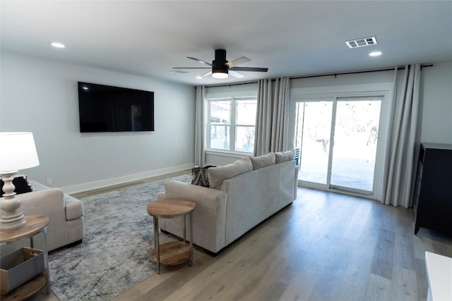 living area featuring baseboards, visible vents, ceiling fan, light wood-type flooring, and recessed lighting