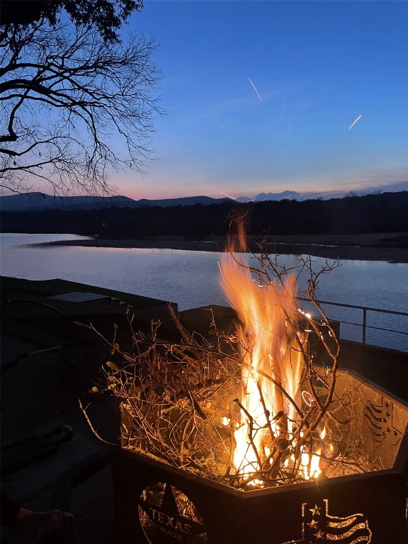 property view of water with an outdoor fire pit