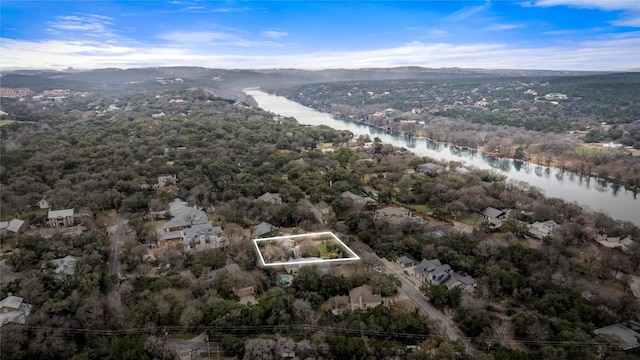 aerial view with a forest view and a water view