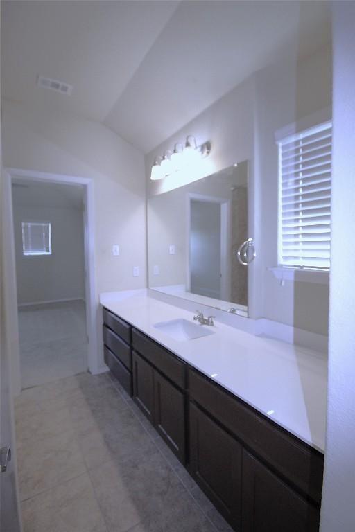 116 Four Star Dr, Elgin, TX 78621 - bathroom featuring vanity, vaulted ceiling, and tile patterned flooring