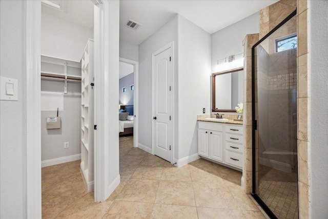 17813 Kingfisher Ridge Dr, Lago Vista, TX 78645 - bathroom featuring vanity, ensuite bathroom, a stall shower, tile patterned floors, and baseboards