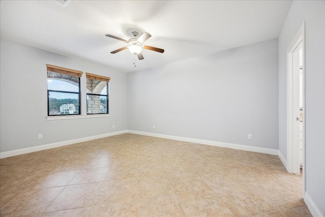17813 Kingfisher Ridge Dr, Lago Vista, TX 78645 - empty room featuring a ceiling fan, baseboards, and light tile patterned floors