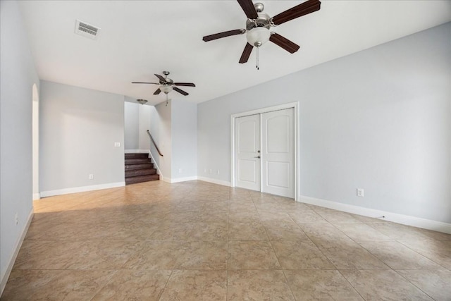 17813 Kingfisher Ridge Dr, Lago Vista, TX 78645 - unfurnished living room featuring ceiling fan, stairs, and baseboards