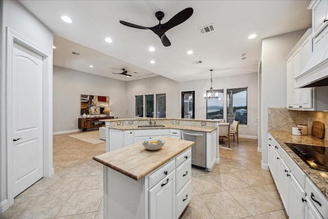 17813 Kingfisher Ridge Dr, Lago Vista, TX 78645 - kitchen featuring a kitchen island, ceiling fan, stainless steel dishwasher, a sink, and black electric cooktop