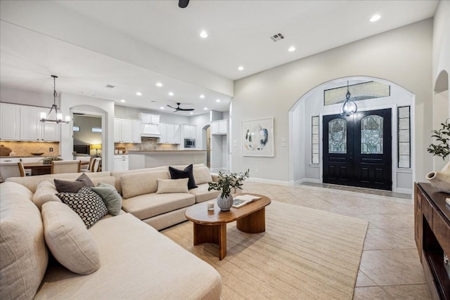 17813 Kingfisher Ridge Dr, Lago Vista, TX 78645 - living area featuring a chandelier, arched walkways, recessed lighting, light tile patterned floors, and a ceiling fan