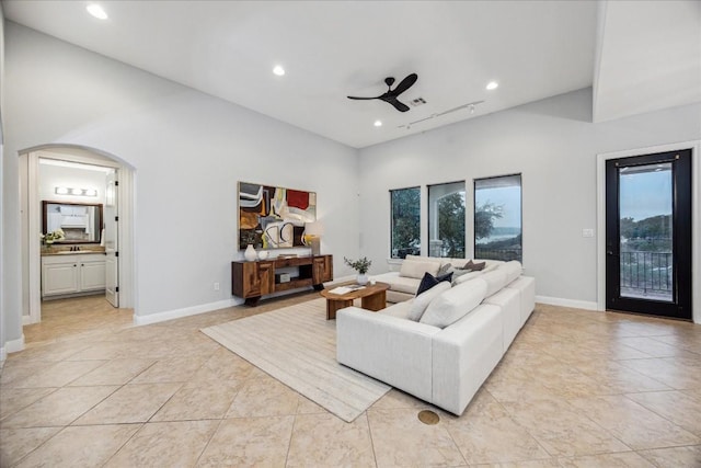 17813 Kingfisher Ridge Dr, Lago Vista, TX 78645 - living area with a ceiling fan, recessed lighting, light tile patterned flooring, arched walkways, and baseboards