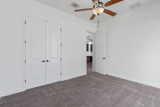 unfurnished bedroom with a closet, carpet flooring, visible vents, and baseboards