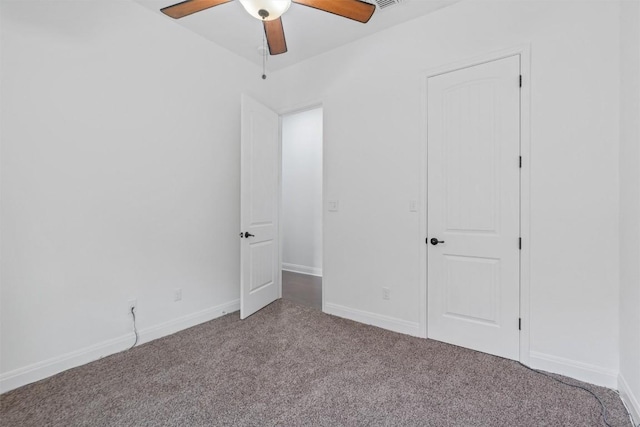 unfurnished bedroom featuring carpet flooring, a ceiling fan, and baseboards