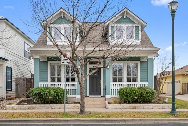 view of front of home featuring a porch and roof with shingles