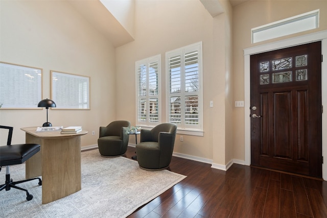 entrance foyer featuring a high ceiling, dark wood-style flooring, and baseboards