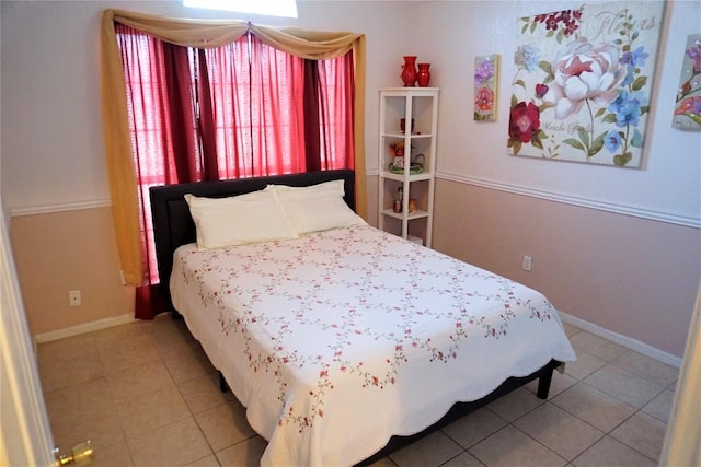 bedroom featuring tile patterned flooring and baseboards