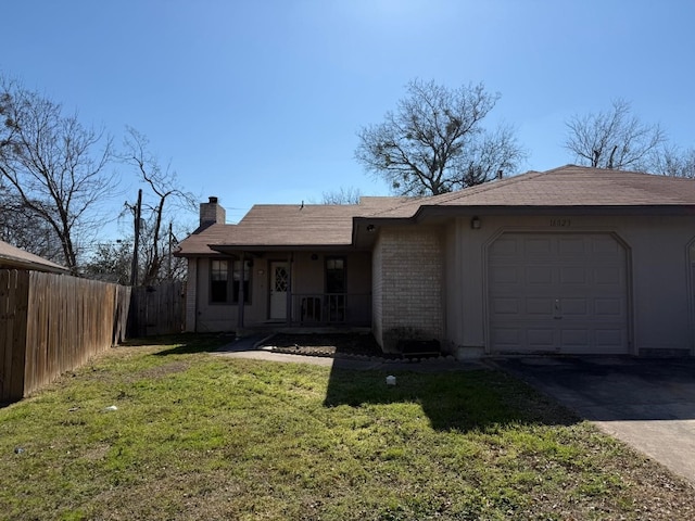 ranch-style home featuring brick siding, a chimney, fence, a garage, and a front lawn