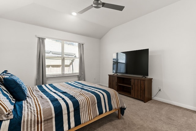 bedroom with lofted ceiling, ceiling fan, baseboards, and light colored carpet