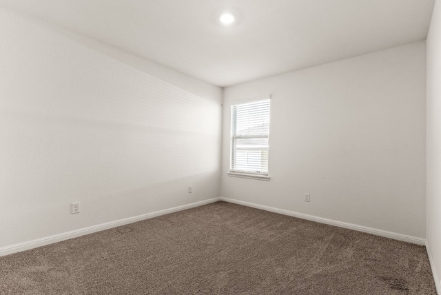 carpeted empty room with baseboards