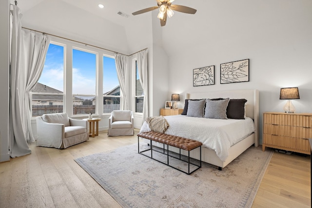 bedroom with recessed lighting, light wood-style flooring, a ceiling fan, visible vents, and high vaulted ceiling