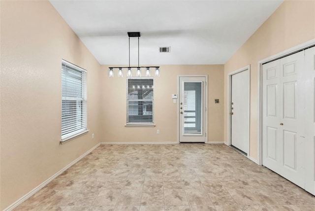 unfurnished dining area with visible vents and baseboards