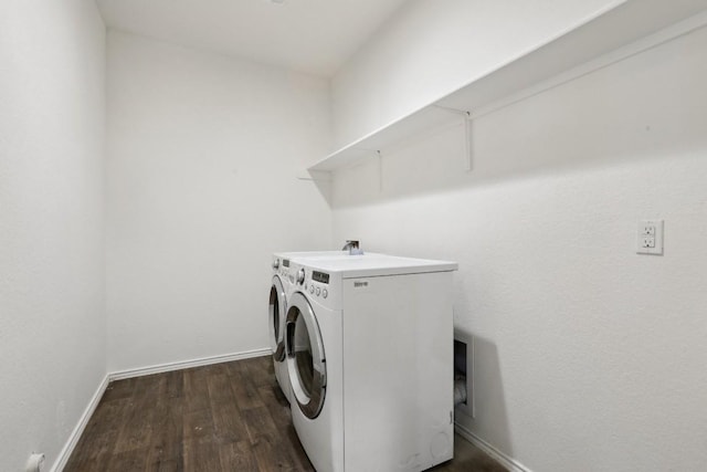 laundry area with laundry area, baseboards, washing machine and clothes dryer, and dark wood-style flooring