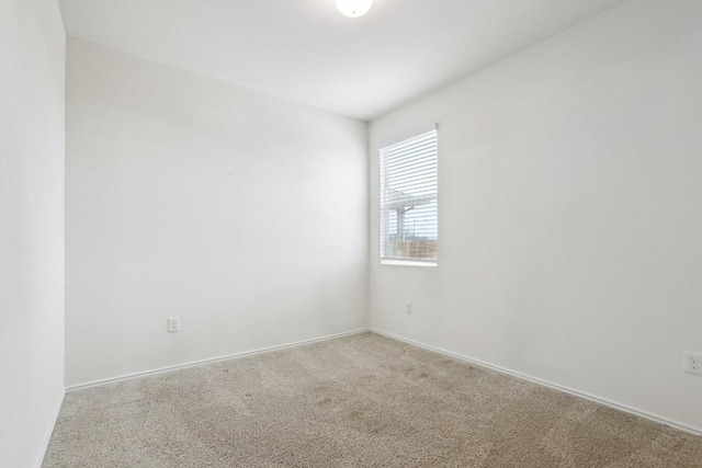 carpeted empty room with baseboards