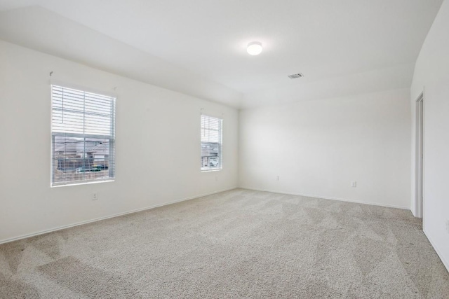 unfurnished room with light carpet, baseboards, and visible vents