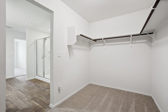 spacious closet featuring visible vents and wood finished floors