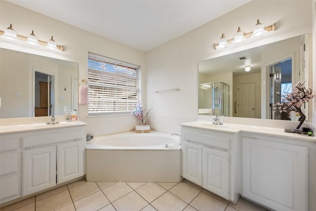 bathroom featuring a garden tub, a sink, two vanities, tile patterned floors, and a stall shower