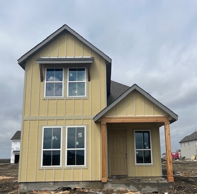 view of front of house featuring a shingled roof and board and batten siding