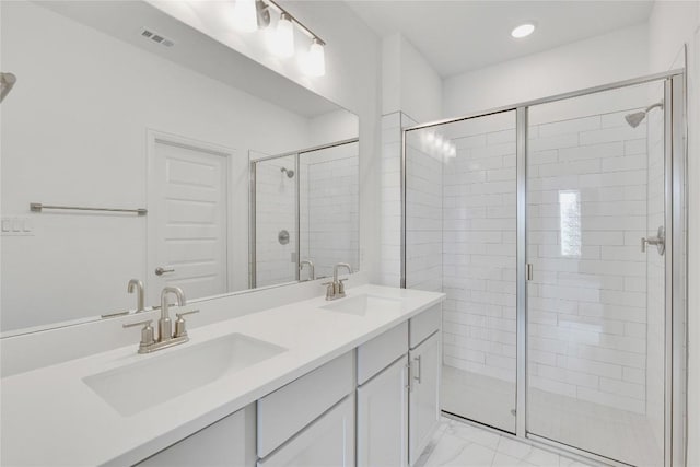 522 Ansley Ct, Taylor, TX 76574 - bathroom with marble look tiles, a shower stall, double vanity, and recessed lighting