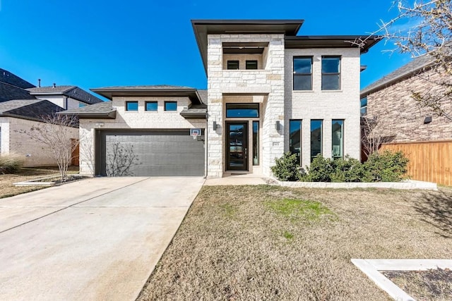 view of front of home featuring a garage, brick siding, fence, stone siding, and concrete driveway