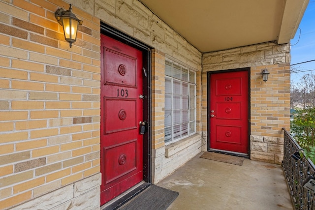 property entrance featuring brick siding