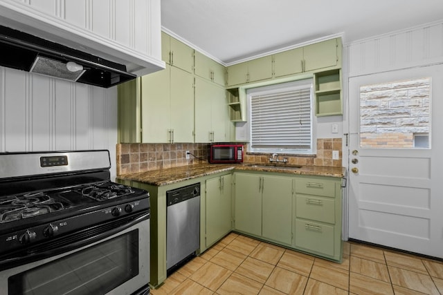 kitchen with appliances with stainless steel finishes, a sink, open shelves, green cabinetry, and exhaust hood