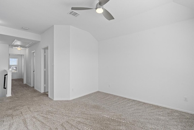 unfurnished room featuring attic access, light carpet, visible vents, and a ceiling fan