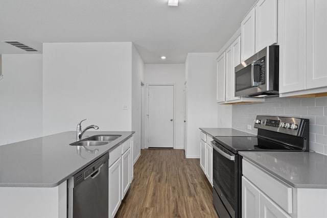 kitchen featuring stainless steel appliances, a sink, visible vents, and white cabinets