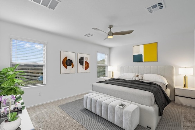 bedroom with ceiling fan, carpet floors, and visible vents