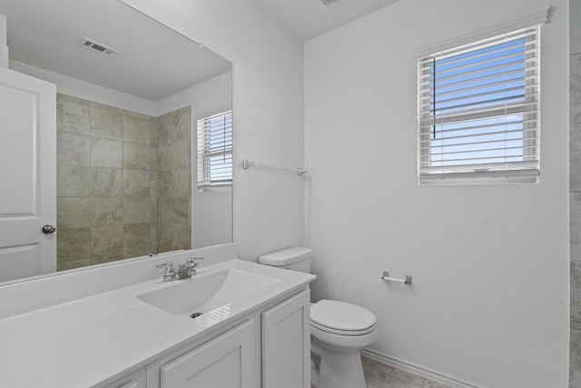 bathroom featuring tile patterned flooring, visible vents, vanity, and toilet