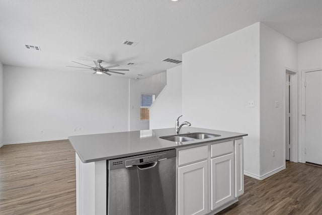 kitchen with stainless steel dishwasher, open floor plan, white cabinetry, a sink, and an island with sink