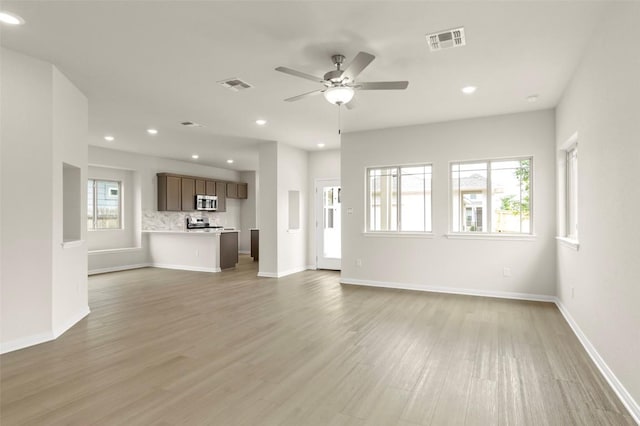 359 Witchhazel Way, San Marcos, TX 78666 - unfurnished living room featuring recessed lighting, ceiling fan, light wood-type flooring, and baseboards