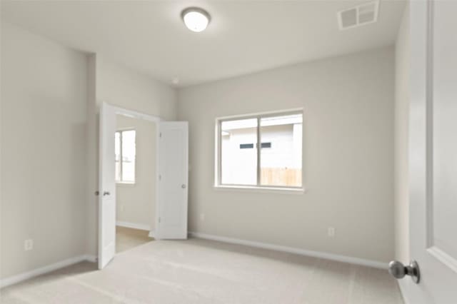 359 Witchhazel Way, San Marcos, TX 78666 - unfurnished bedroom with light colored carpet, multiple windows, and baseboards
