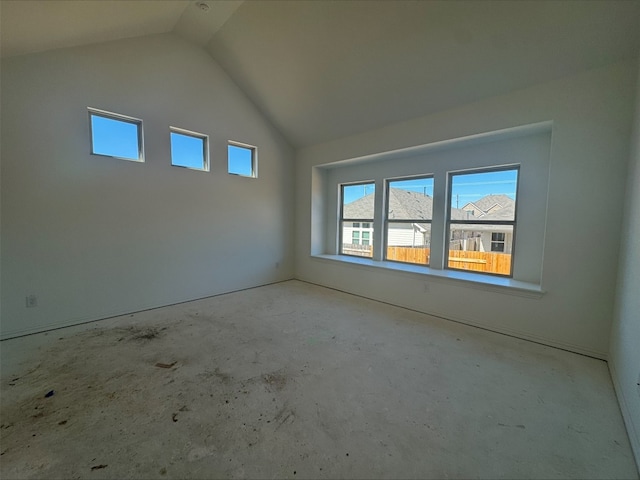 spare room featuring lofted ceiling