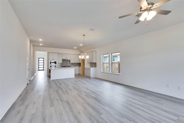 263 Diamondleaf Dr, Buda, TX 78610 - unfurnished living room with light wood-style floors, a chandelier, recessed lighting, baseboards, and ceiling fan