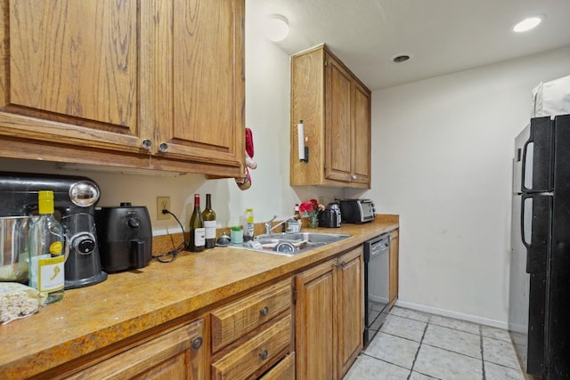 2529 Rio Grande St Unit 7, Austin, TX 78705 - kitchen with black appliances, light tile patterned flooring, brown cabinets, and light countertops