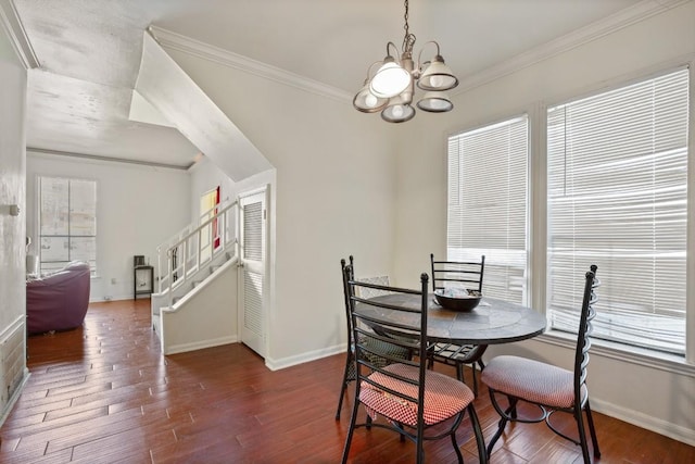 dining space with dark wood-style floors, a wealth of natural light, ornamental molding, and stairs