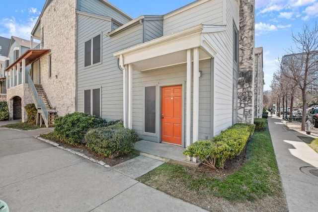 2529 Rio Grande St Unit 7, Austin, TX 78705 - view of front of home with stairs, a chimney, and stone siding