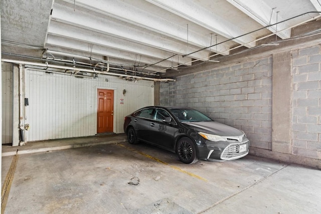 parking garage featuring concrete block wall