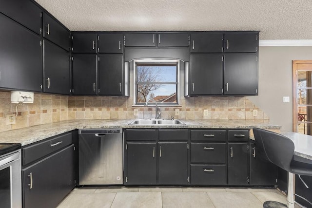 kitchen featuring a wealth of natural light, a sink, stainless steel dishwasher, and light tile patterned floors