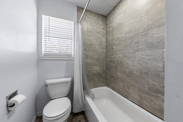 full bathroom featuring shower / tub combo and toilet