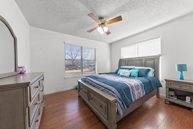 bedroom featuring baseboards, a textured ceiling, a ceiling fan, and dark wood-type flooring