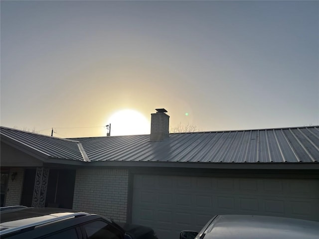 view of garage at dusk