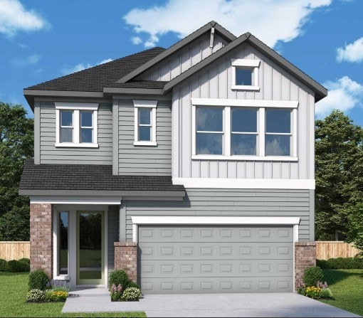 view of front of property featuring a garage, driveway, brick siding, and board and batten siding