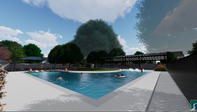 community pool with a patio area and fence