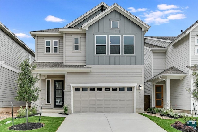 view of front of home featuring board and batten siding, a garage, driveway, and a shingled roof